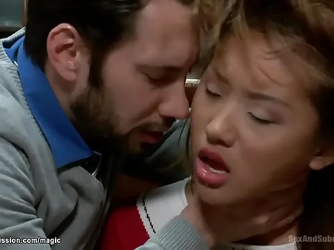 Asian schoolgirl, tied and gagged, submits to intense bondage force.