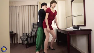 A mature Asian woman gets assistance from her stepson in